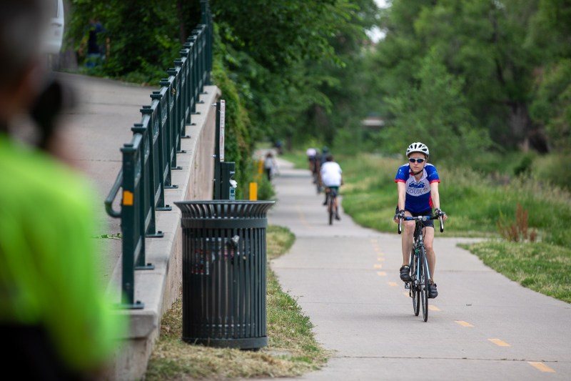 Park Ranger Eric Knopinski uses a radar gun to clock the speed of a cyclist on the Cherry Creek Trail.