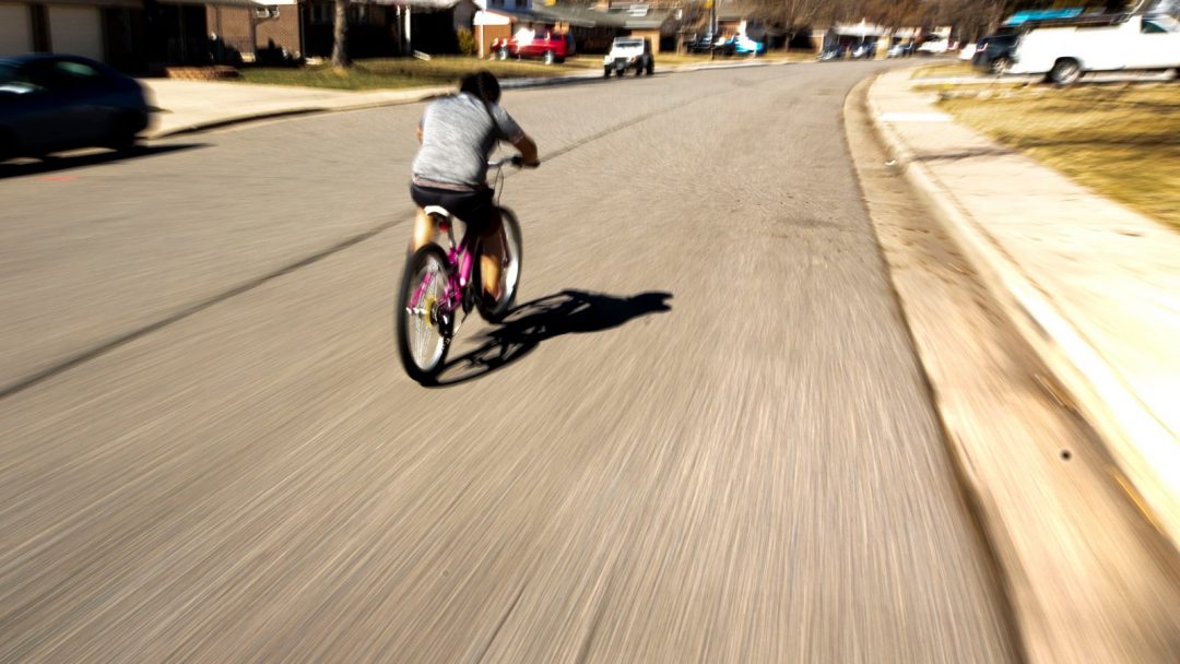 Boy riding bike on Denver Streets