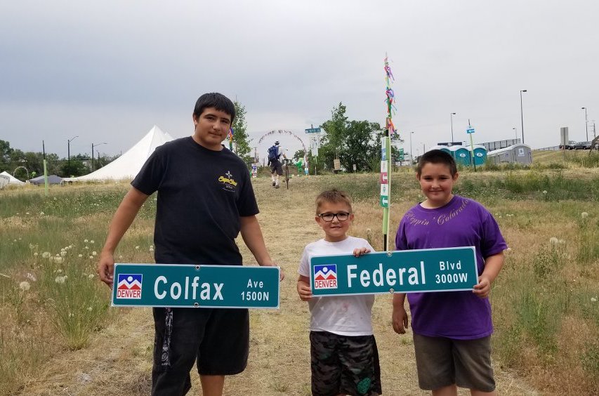 People holding Colfax & federal signs