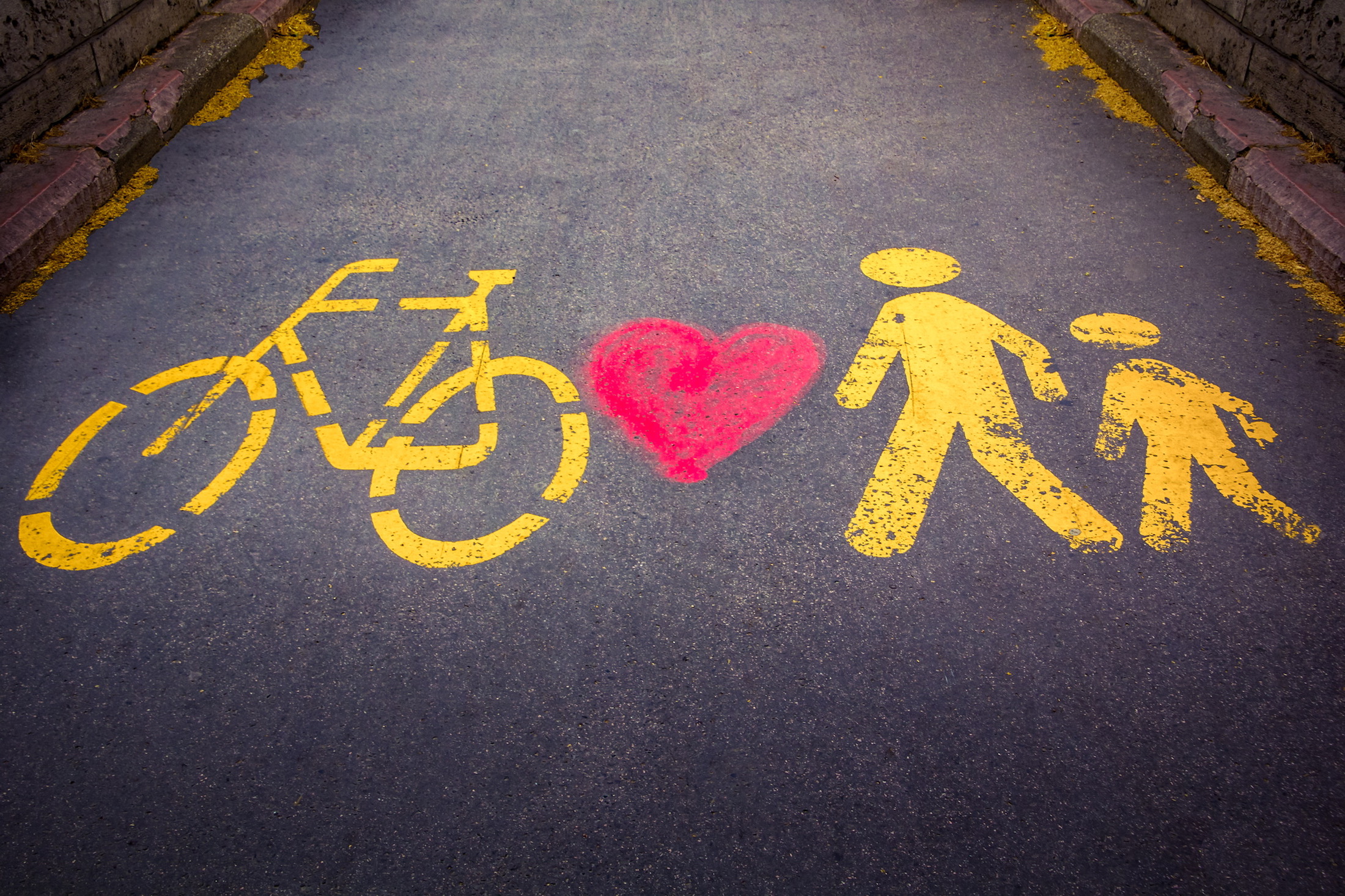 Bike, heart, and pedestrians stenciled on street