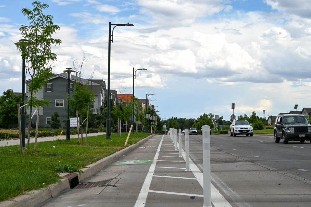 A bike lane with a median and flex posts separating it from motorist traffic lanes to the right.