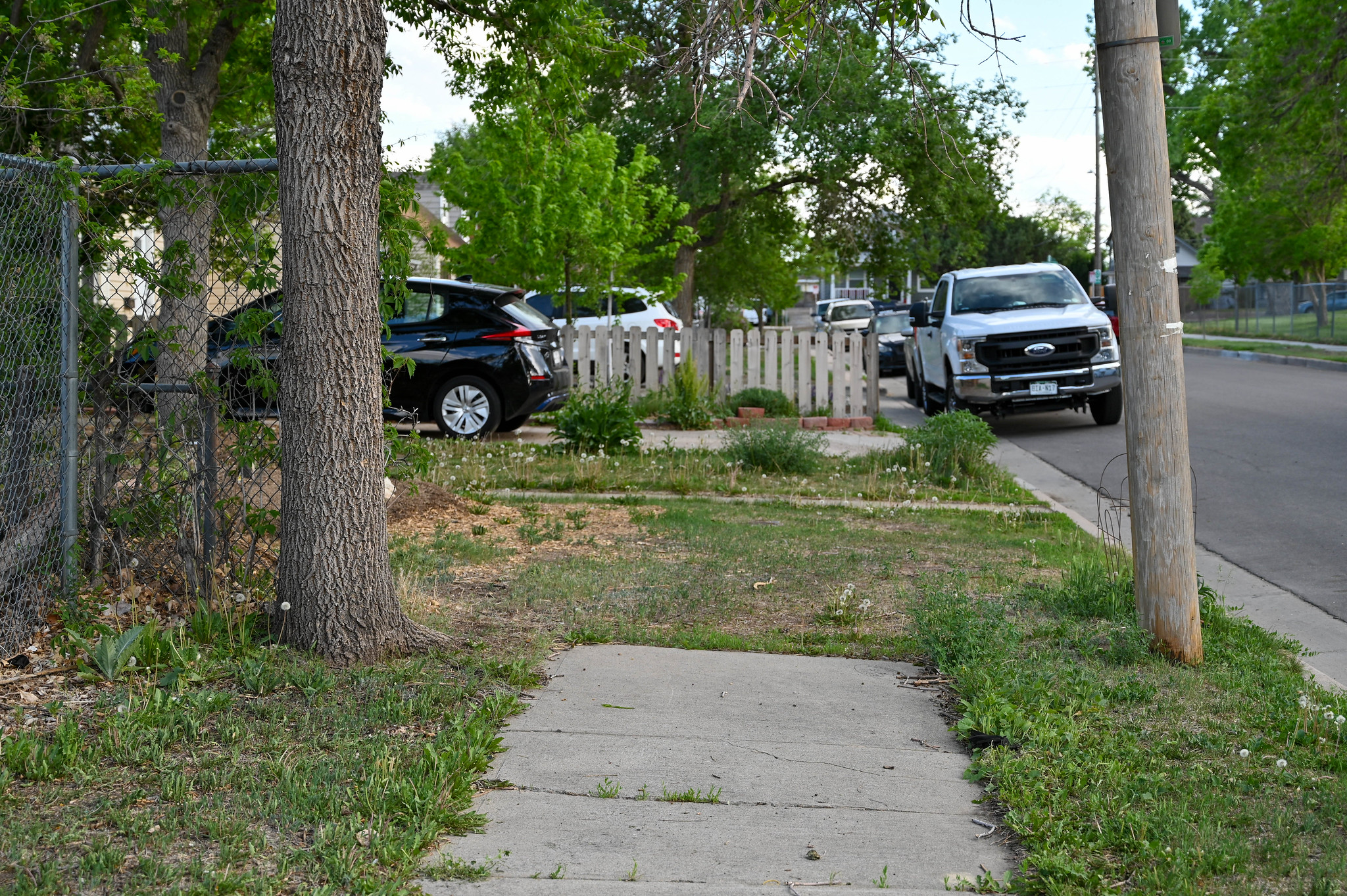 A sidewalk that abruptly ends mid block against a yard.