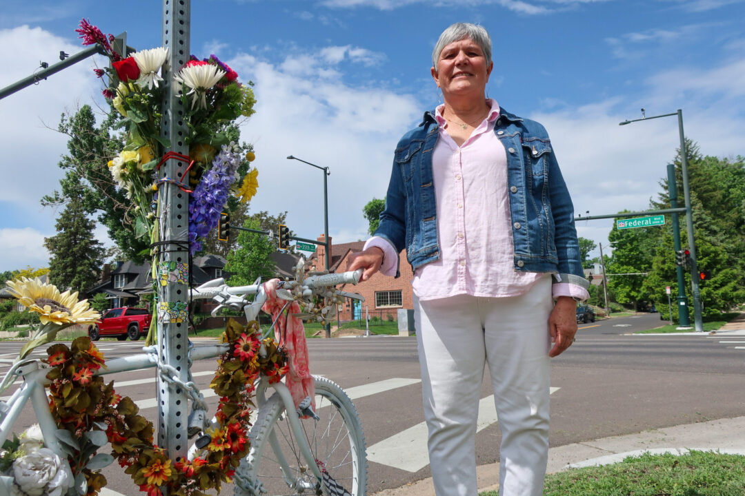 Cindy Stepp of Denver stands next to a ghost bike memorial for her daughter Ainslie O'Neil