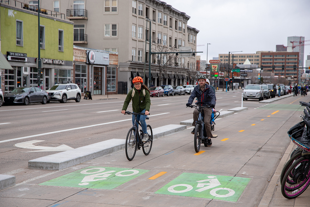 People riding bikes down the new two-way bikeway on South Broadway.